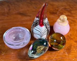 This lot features an assortment of blown glass items including a Murano perfume bottle, an artist signed paperweight, and more.
