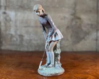"Lady Golfer", a vintage retired Lladro porcelain figurine, model number 4851. This sculpture is in excellent condition and measures, 11” H x 4” W x 5” D.
