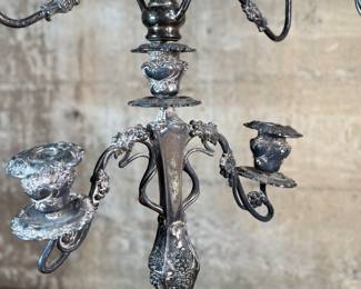 This lot features a pair of antique French Louis XVI style candelabras. Each one measures, 25” H x 16” W x 7” D.
