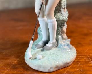 "Lady Golfer", a vintage retired Lladro porcelain figurine, model number 4851. This sculpture is in excellent condition and measures, 11” H x 4” W x 5” D.
