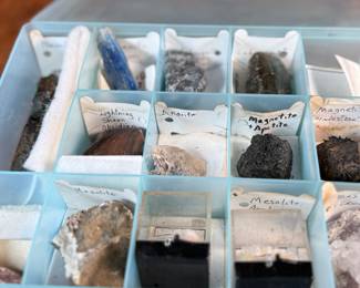 This lot features five (5) cases of rocks and minerals, many of them labeled in their containers.
