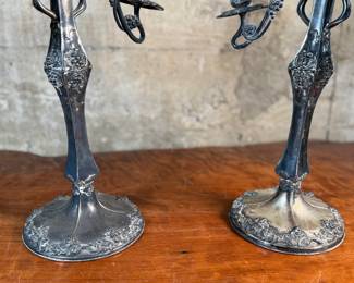 This lot features a pair of antique French Louis XVI style candelabras. Each one measures, 25” H x 16” W x 7” D.
