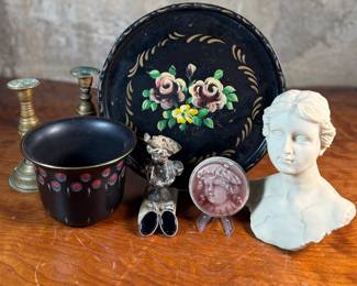 This lot features a collection of antiques and collectibles including sculpture, brass candlesticks, a Zwaro pottery vase, and more.
