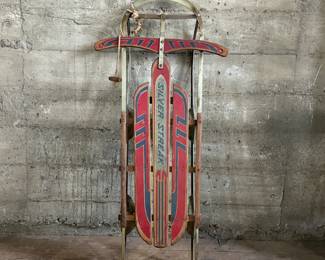 This lot features an antique “Silver Streak” sled that measures, 46” H x 22” W x 6” D.
