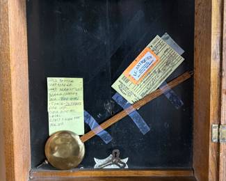 This lot features an antique clock made by the Waterbury Clock Company, with an advertising glass panel for Macdonald Jewelry Company. Appears complete with key, pendulum, instructions, and service records. This clock measures, 35” H x 16” W x 5” D. The Waterbury Clock Company factory is a historic complex of factory buildings in Waterbury, Connecticut. Development began in 1873, with the extensive plant serving as the company’s main manufacturing facility and headquarters until 1944.
