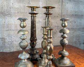 This lot features a collection of six (6) antique brass candlesticks. Three matching pairs with the tallest measuring, 17” H.
