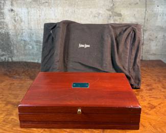 This lot features a stunning set of flatware by Christofle for Neiman Marcus. Each piece is beautifully marked as shown in photos, accompanied with Neiman Marcus covers, and housed in a vintage flatware box for safe storage. Christofle was founded in Paris in 1830 by Charles Christofle, who gained a reputation for his innovative silver plating technology and became a purveyor to the French court. The company grew significantly, supplying its flatware to royalty and even making its mark at international exhibitions, earning awards until at least 1937. Key moments in its history include acquiring the patents for electroplating in 1842, creating the America flatware collection in 1933, and introducing the Aria collection in 1985. 
This set includes two (2) large spoons, one (1) server, one (1) large fork, three (3) knives, twelve (12) big spoons, twelves (12) big forks, twelve (12) standard spoons, and eight (8) standard forks.