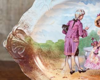 This lot features an antique Limoges porcelain plate with a hand-painted scene. Marker mark underneath as shown in photos and measures, 13.25” H x 18.5” W. 
