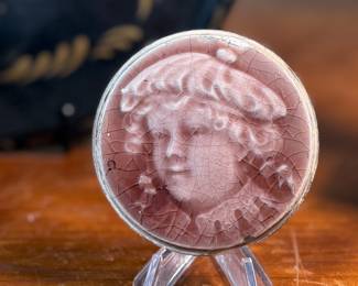 This lot features a collection of antiques and collectibles including sculpture, brass candlesticks, a Zwaro pottery vase, and more.
