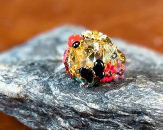 This lot features a reproduction of a ladybug floral enamel gold ring, originally made in 18k by Dior. This piece is believed to be a quality reproduction and is made of sterling silver. Marked 925 and comes in a size 8.
