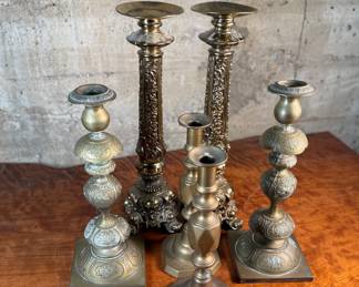 This lot features a collection of six (6) antique brass candlesticks. Three matching pairs with the tallest measuring, 17” H.
