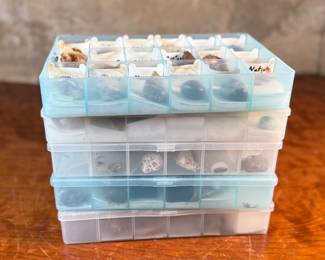 This lot features five (5) cases of rocks and minerals, many of them labeled in their containers.
