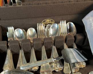 This lot features a stunning set of flatware by Christofle for Neiman Marcus. Each piece is beautifully marked as shown in photos, accompanied with Neiman Marcus covers, and housed in a vintage flatware box for safe storage. Christofle was founded in Paris in 1830 by Charles Christofle, who gained a reputation for his innovative silver plating technology and became a purveyor to the French court. The company grew significantly, supplying its flatware to royalty and even making its mark at international exhibitions, earning awards until at least 1937. Key moments in its history include acquiring the patents for electroplating in 1842, creating the America flatware collection in 1933, and introducing the Aria collection in 1985. 
This set includes two (2) large spoons, one (1) server, one (1) large fork, three (3) knives, twelve (12) big spoons, twelves (12) big forks, twelve (12) standard spoons, and eight (8) standard forks.