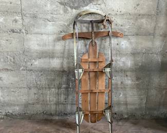 This lot features an antique “Silver Streak” sled that measures, 46” H x 22” W x 6” D.
