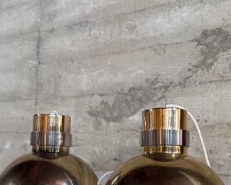 This lot features a pair of mid-century modern style brass pendant lights, manufactured by The Feldman Company, circa 1970s. Each one measures, 13” H x 16” W x 16” D.
