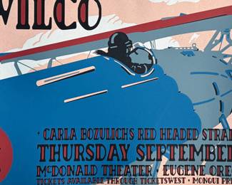 This lot features a rare signed and numbered silkscreen print from Wilco’s 2003 McDonald Theater performance with Carla Bozulich’s Red Headed Stranger. Numbered 102/165 and signed in pencil by artist, Gary Houston. This print measures, 18” H x 24” W.
