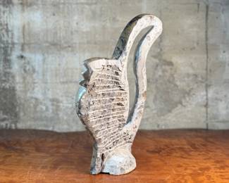 This lot features a stunning polished fossil sculpture featuring embedded ammonite and orthoceras fossils. This sculpture measures, 17.5” H x 12” W x 4” D.
