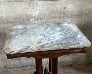 This lot features an antique Eastlake Victorian carved walnut parlor table with a marble top that measures, 28.5” H x 24” W x 16” D.
