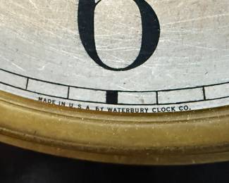This lot features an antique clock made by the Waterbury Clock Company, with an advertising glass panel for Macdonald Jewelry Company. Appears complete with key, pendulum, instructions, and service records. This clock measures, 35” H x 16” W x 5” D. The Waterbury Clock Company factory is a historic complex of factory buildings in Waterbury, Connecticut. Development began in 1873, with the extensive plant serving as the company’s main manufacturing facility and headquarters until 1944.
