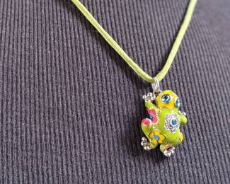 This lot features a Belle Étoile Lucky Frog pendant featuring hand-painted enameling in green, yellow, red, and blue. The pendant is made of sterling silver and marked 925 on the back as shown in photos. The pendant measures, 1.25” H x 1” W with a total approx. weight of 15.00 grams.
