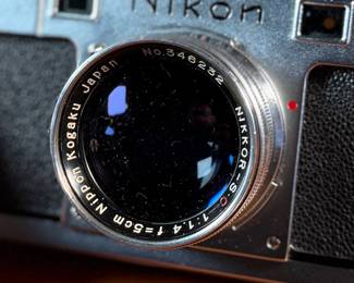 The lot features a vintage Nikon S rangefinder camera with a Nikkor-S 5cm f/1.4 lens. The Nikon S was the first Nikon camera to be imported to the US market. Tested and in good working condition.
