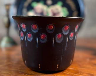 This lot features a collection of antiques and collectibles including sculpture, brass candlesticks, a Zwaro pottery vase, and more.
