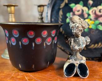 This lot features a collection of antiques and collectibles including sculpture, brass candlesticks, a Zwaro pottery vase, and more.
