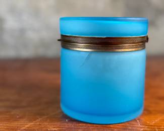 This lot features a vintage French blue opaline glass lidded keepsake box with brass trim that measures, 5” H x 4.75” W x 4.75” D. One small interior crack as shown in photos.
