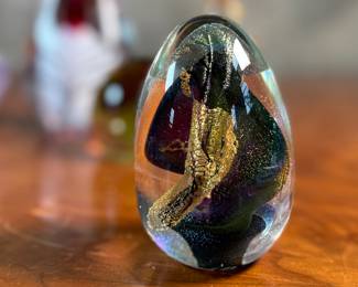 This lot features an assortment of blown glass items including a Murano perfume bottle, an artist signed paperweight, and more.
