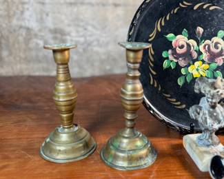This lot features a collection of antiques and collectibles including sculpture, brass candlesticks, a Zwaro pottery vase, and more.
