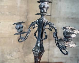 This lot features a pair of antique French Louis XVI style candelabras. Each one measures, 25” H x 16” W x 7” D.
