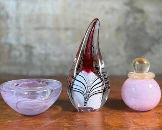 This lot features an assortment of blown glass items including a Murano perfume bottle, an artist signed paperweight, and more.
