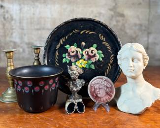 This lot features a collection of antiques and collectibles including sculpture, brass candlesticks, a Zwaro pottery vase, and more.
