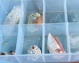 This lot features five (5) cases of rocks and minerals, many of them labeled in their containers.
