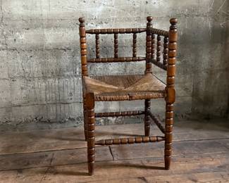 This lot features a Dutch bobbin corner chair with a rush seat, likely from the 1920s that measures, 29” H x 16” W x 16” D.
