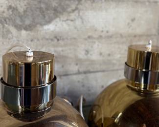 This lot features a pair of mid-century modern style brass pendant lights, manufactured by The Feldman Company, circa 1970s. Each one measures, 13” H x 16” W x 16” D.
