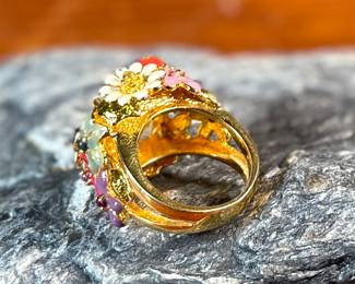 This lot features a reproduction of a ladybug floral enamel gold ring, originally made in 18k by Dior. This piece is believed to be a quality reproduction and is made of sterling silver. Marked 925 and comes in a size 8.
