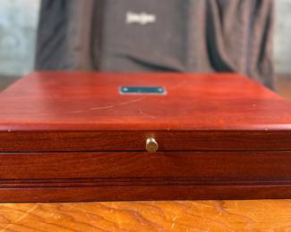 This lot features a stunning set of flatware by Christofle for Neiman Marcus. Each piece is beautifully marked as shown in photos, accompanied with Neiman Marcus covers, and housed in a vintage flatware box for safe storage. Christofle was founded in Paris in 1830 by Charles Christofle, who gained a reputation for his innovative silver plating technology and became a purveyor to the French court. The company grew significantly, supplying its flatware to royalty and even making its mark at international exhibitions, earning awards until at least 1937. Key moments in its history include acquiring the patents for electroplating in 1842, creating the America flatware collection in 1933, and introducing the Aria collection in 1985. 
This set includes two (2) large spoons, one (1) server, one (1) large fork, three (3) knives, twelve (12) big spoons, twelves (12) big forks, twelve (12) standard spoons, and eight (8) standard forks.