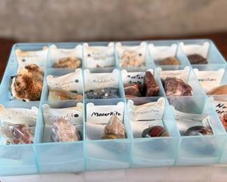 This lot features five (5) cases of rocks and minerals, many of them labeled in their containers.
