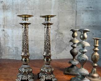 This lot features a collection of six (6) antique brass candlesticks. Three matching pairs with the tallest measuring, 17” H.
