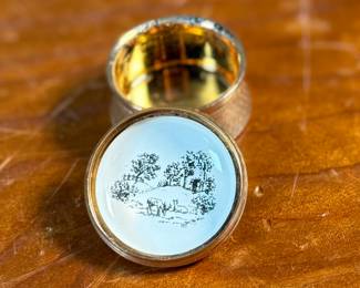 This lot features a porcelain figurine titled, "Cat and Mouse", manufactured by Lladro (model number 5236) & a cat themed trinket box manufactured by Bilston and Battersea. Bilston and Battersea enamels are fine English enamelware, originally produced in the 18th century and revived in the 20th century, known for decorative items like trinket boxes, pillboxes, and other luxury goods
