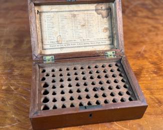 This lot features an antique wooden homeopathic apothecary box used to store various vials of homeopathic remedies. This box measures, 2.75” H x 7.75” W x 5” D.
