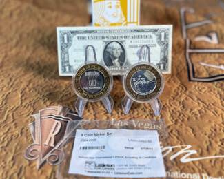 The Las Vegas lot! This lot features two coins featuring .999 fine silver, a bag of proof nickels, a new sealed card set, three (3) silver certificates, and a Baccarat table cover from The Hilton in Las Vegas.
