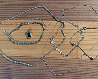 This lot features a collection of sterling silver jewelry including bracelets, chains, and a pendant with a total approx. weight of 23.84 grams.
