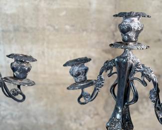 This lot features a pair of antique French Louis XVI style candelabras. Each one measures, 25” H x 16” W x 7” D.
