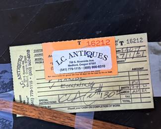 This lot features an antique clock made by the Waterbury Clock Company, with an advertising glass panel for Macdonald Jewelry Company. Appears complete with key, pendulum, instructions, and service records. This clock measures, 35” H x 16” W x 5” D. The Waterbury Clock Company factory is a historic complex of factory buildings in Waterbury, Connecticut. Development began in 1873, with the extensive plant serving as the company’s main manufacturing facility and headquarters until 1944.
