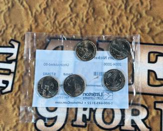 The Las Vegas lot! This lot features two coins featuring .999 fine silver, a bag of proof nickels, a new sealed card set, three (3) silver certificates, and a Baccarat table cover from The Hilton in Las Vegas.
