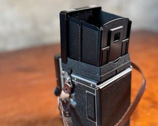 The lot features a Rollei Magic twin-lens reflex (TLR) camera. This vintage medium format camera was produced by the German company Franke & Heidecke between 1960 and 1962. It uses 120 film and produces 6×6 cm images. The camera features a 75mm f/3.5 Schneider Xenar taking lens and a 75mm f/3.5 Heidosmat viewing lens. A key feature of the Rollei Magic is its automatic exposure system, which relies on a built-in selenium light meter. The camera’s design is based on the Rolleicord series and was an early attempt at an automatic camera in the medium format market. Tested and in good working condition.
