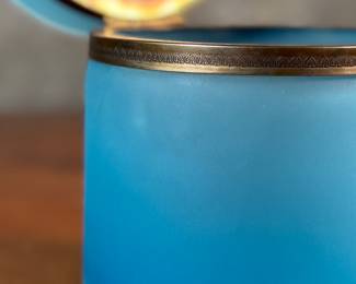 This lot features a vintage French blue opaline glass lidded keepsake box with brass trim that measures, 5” H x 4.75” W x 4.75” D. One small interior crack as shown in photos.

