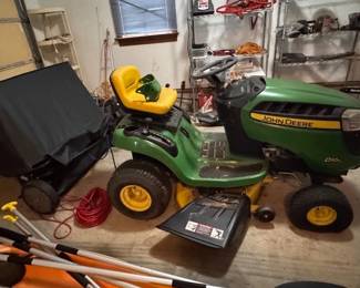 John Deere D100 lawn mower with a Brinly leaf catcher